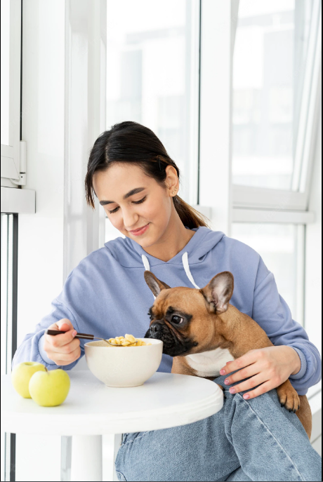 woman eating with dog